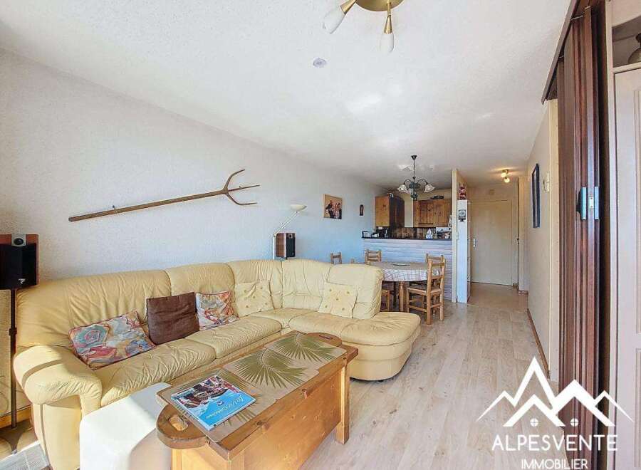 Discover this charming property featuring a cozy living area with a comfortable sofa and a unique decorative pitchfork.