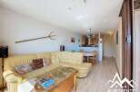 Discover this charming property featuring a cozy living area with a comfortable sofa and a unique decorative pitchfork.