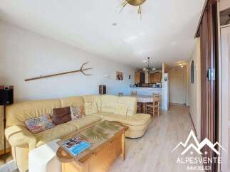 Discover this charming property featuring a cozy living area with a comfortable sofa and a unique decorative pitchfork.