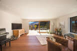 This stunning living room boasts a warm and inviting atmosphere, perfect for relaxation and entertaining.