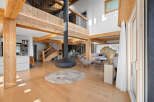 Experience luxury living in this stunning property featuring exposed wooden beams and a modern fireplace.