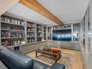 This luxurious living room boasts custom built-in shelving, perfect for displaying books and decor.