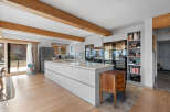 This stunning kitchen boasts a modern design with sleek white cabinetry and a large island, perfect for both cooking and entertaining.