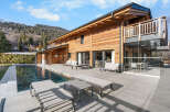 Experience luxury living in this stunning wooden chalet, complete with a private pool and expansive outdoor patio.