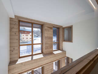 Experience the charm of this stunning property, featuring a unique wooden interior and expansive windows.