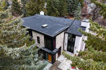 This stunning modern home boasts a sleek, contemporary design with a flat roof and stylish brick facade.