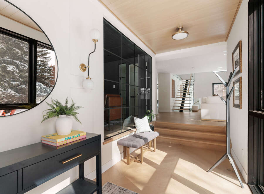 Step into luxury with this stunning entryway, showcasing a modern design with sleek lines and natural light.