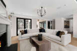 Experience luxury living in this stunning property, featuring a spacious living room with a modern white sectional sofa.