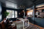 Step into luxury with this stunning home office, featuring a sophisticated dark color palette and custom built-ins.