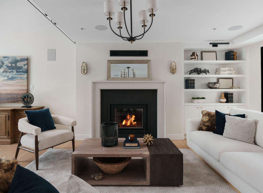 Experience luxury living in this stunning property, featuring a cozy fireplace and elegant built-in shelves.