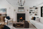 Experience luxury living in this stunning property, featuring a cozy fireplace and elegant built-in shelves.