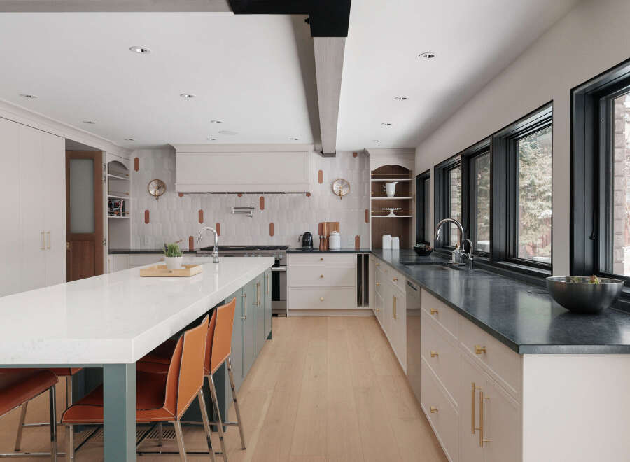 This stunning kitchen boasts a modern design with sleek countertops and ample storage.