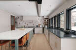 This stunning kitchen boasts a modern design with sleek countertops and ample storage.