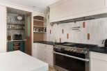 This stunning kitchen boasts a modern design with high-end appliances and ample storage.