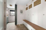 Step into this stylish entryway, featuring a custom built-in bench with ample storage and a warm wood top.