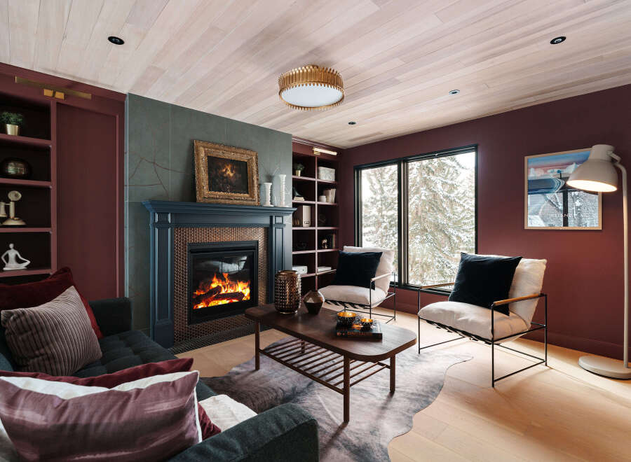 Experience the warmth and elegance of this stunning living room, featuring a cozy fireplace and stylish seating.