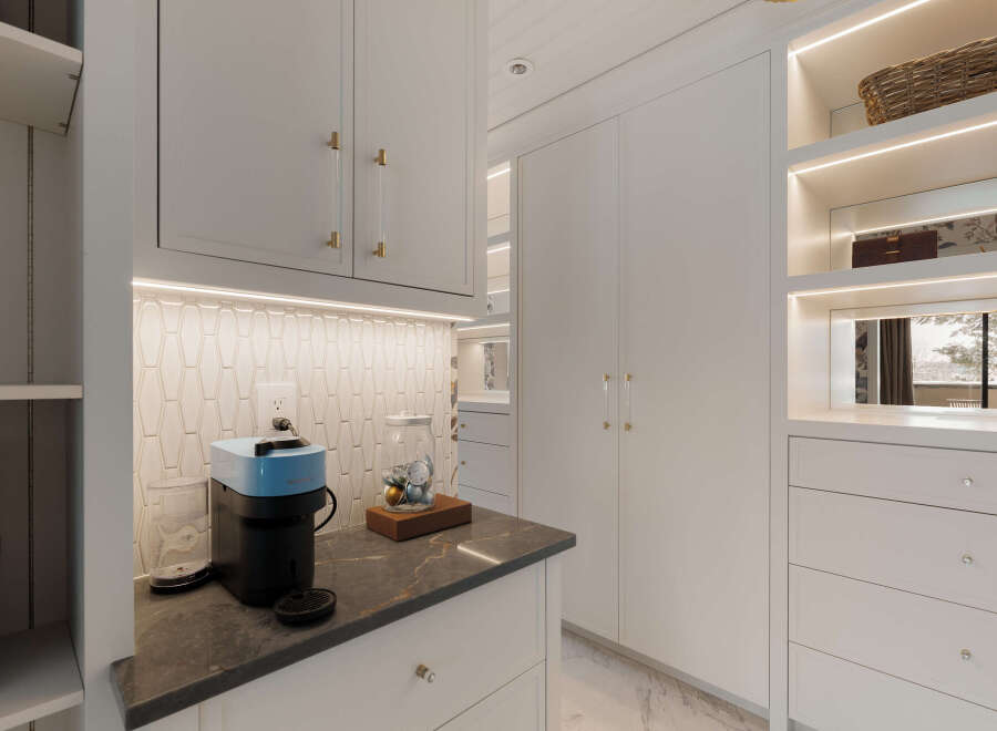 This stunning kitchen boasts a modern design with sleek white cabinetry and elegant gold hardware.