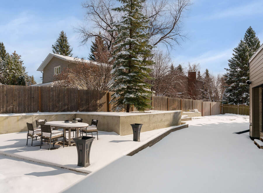 Enjoy the serene beauty of this property's backyard, perfect for winter relaxation.