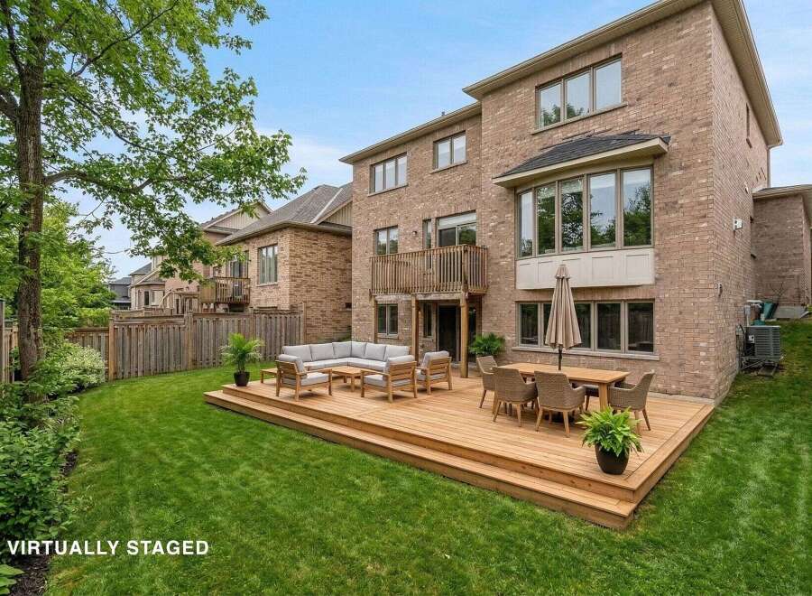 Enjoy outdoor living at its finest with this stunning property featuring a spacious wooden deck, perfect for entertaining or relaxing.