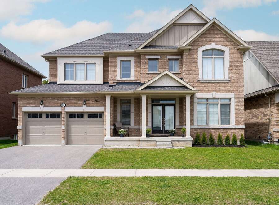 This stunning two-story home boasts a beautiful brick exterior and a well-manicured lawn, perfect for curb appeal.