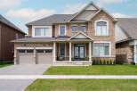 This stunning two-story home boasts a beautiful brick exterior and a well-manicured lawn, perfect for curb appeal.