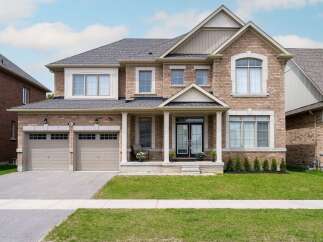 This stunning two-story home boasts a beautiful brick exterior and a well-manicured lawn, perfect for curb appeal.
