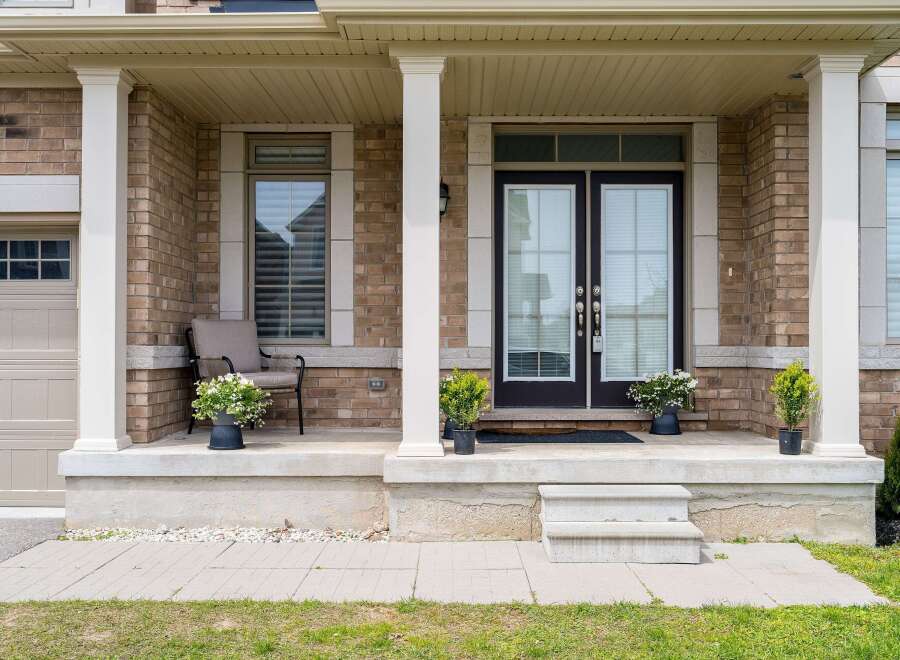 Welcome to this stunning property featuring a charming front porch with elegant columns and a welcoming entrance.