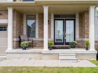 Welcome to this stunning property featuring a charming front porch with elegant columns and a welcoming entrance.