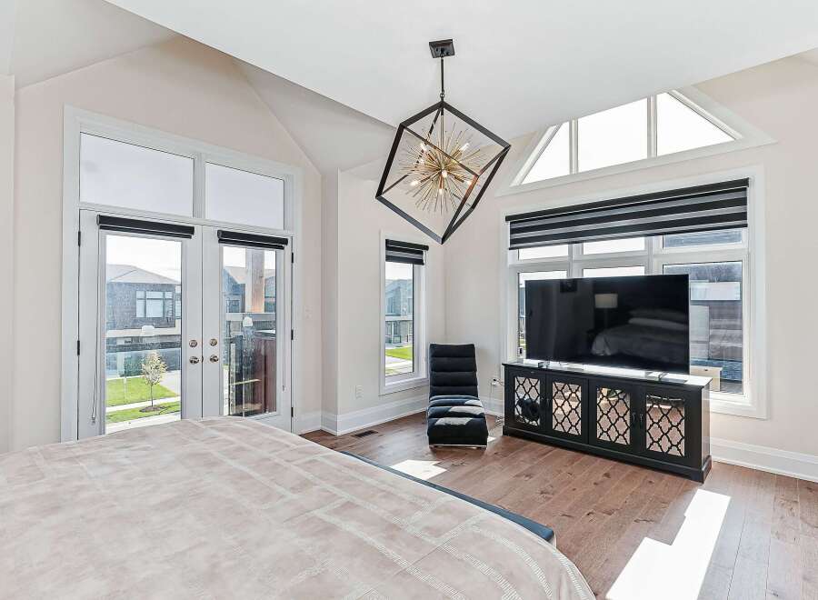Step into luxury with this stunning bedroom, featuring a modern design and ample natural light.