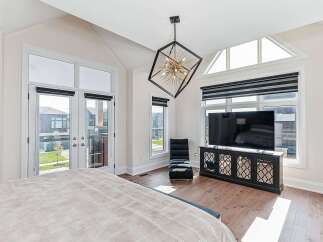 Step into luxury with this stunning bedroom, featuring a modern design and ample natural light.
