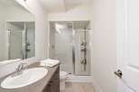 This modern bathroom features a sleek design with a glass-enclosed shower and a stylish vanity.