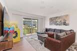 This stunning living room boasts a modern design with a cozy sectional sofa, perfect for relaxing.