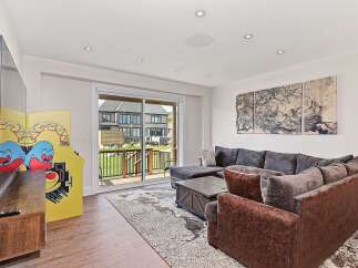 This stunning living room boasts a modern design with a cozy sectional sofa, perfect for relaxing.