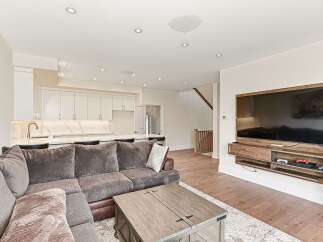 Step into luxury with this stunning living space! Featuring a modern kitchen with sleek cabinetry and a spacious layout, perfect for entertaining.