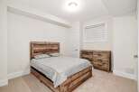 This bedroom showcases rustic charm with its wooden bed frame and dresser, creating a warm and inviting atmosphere.