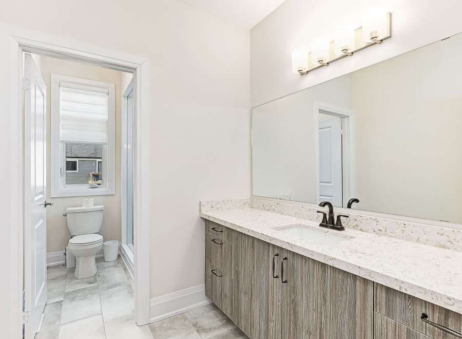 This stunning bathroom boasts a modern design with a sleek vanity and a beautiful countertop.