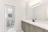 This stunning bathroom boasts a modern design with a sleek vanity and a beautiful countertop.