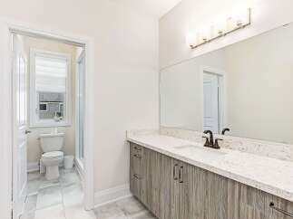 This stunning bathroom boasts a modern design with a sleek vanity and a beautiful countertop.