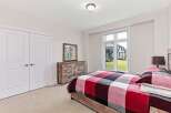 This inviting bedroom showcases a cozy and stylish design.