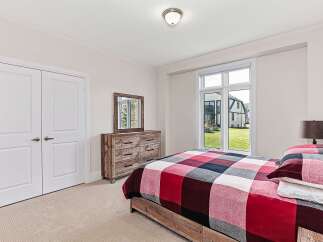This inviting bedroom showcases a cozy and stylish design.