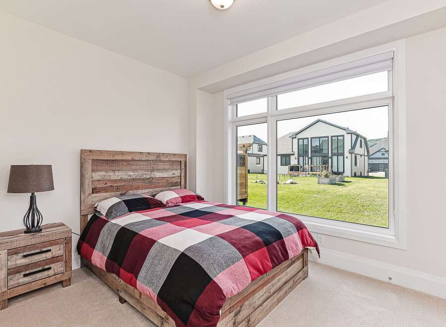 This bedroom features a rustic wooden bed frame and headboard, creating a warm and inviting atmosphere.