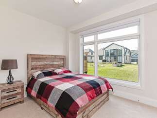 This bedroom features a rustic wooden bed frame and headboard, creating a warm and inviting atmosphere.