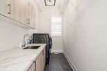 Discover the epitome of modern living in this stunning laundry room.