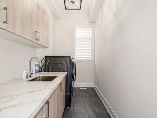 Discover the epitome of modern living in this stunning laundry room.