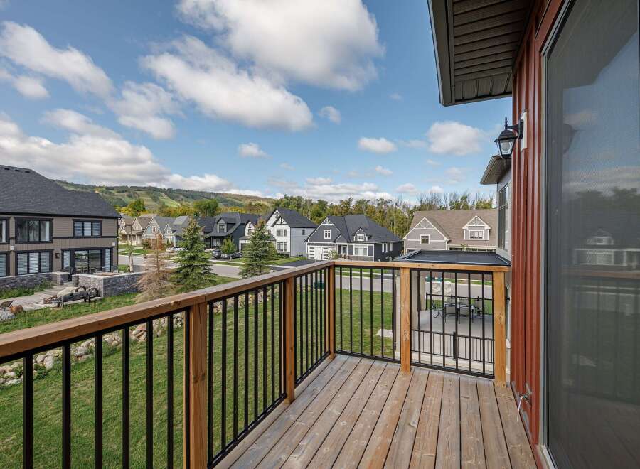 Enjoy stunning views from this beautiful property! This home features a spacious deck with a modern railing system, perfect for relaxing and entertaining.