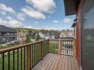 Enjoy stunning views from this beautiful property! This home features a spacious deck with a modern railing system, perfect for relaxing and entertaining.