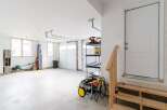 This spacious garage offers ample room for vehicles and storage, perfect for homeowners seeking extra space.