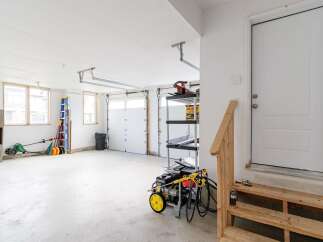 This spacious garage offers ample room for vehicles and storage, perfect for homeowners seeking extra space.