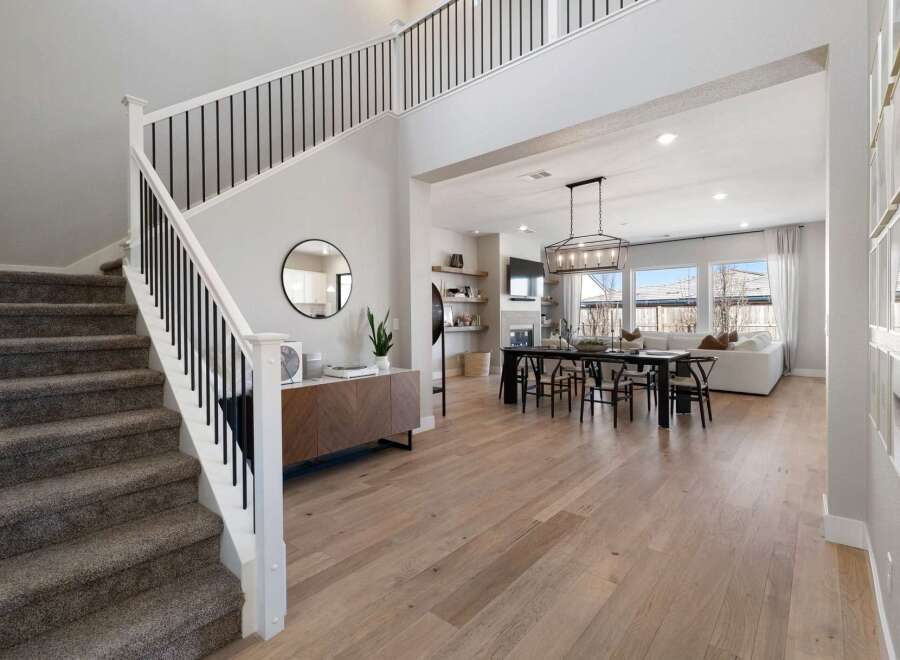 Step into luxury with this stunning property featuring a grand staircase and an open-concept living space.
