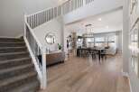 Step into luxury with this stunning property featuring a grand staircase and an open-concept living space.